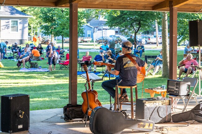 A musician plays a guitar and sings at Neighborhood Nights in Historic East Urbana.