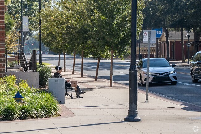 Standing at the bus stop in the charming Duckpond area.
