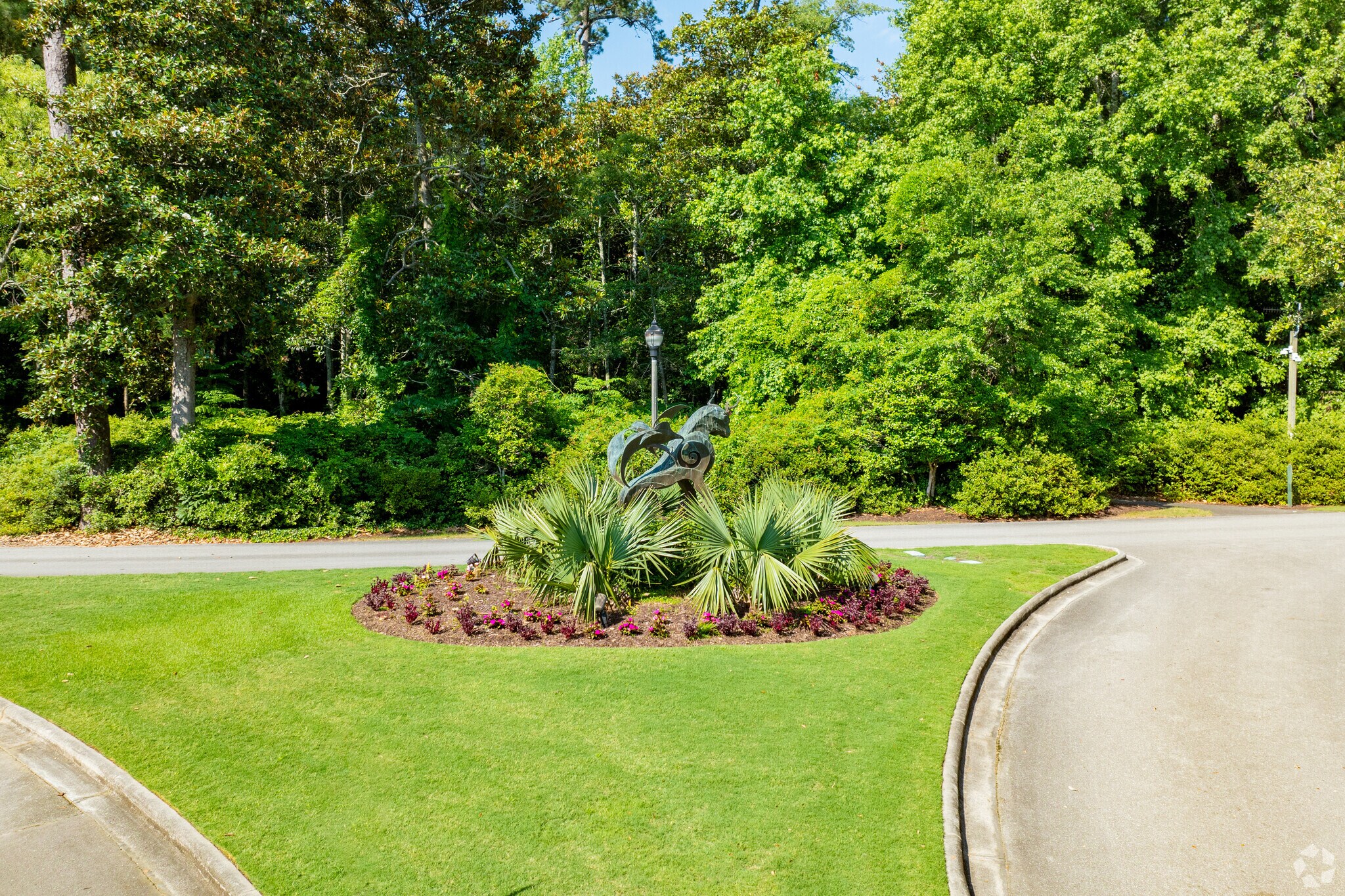 Sculptures and ornamental greenery adorn the grounds of Airlie Gardens.