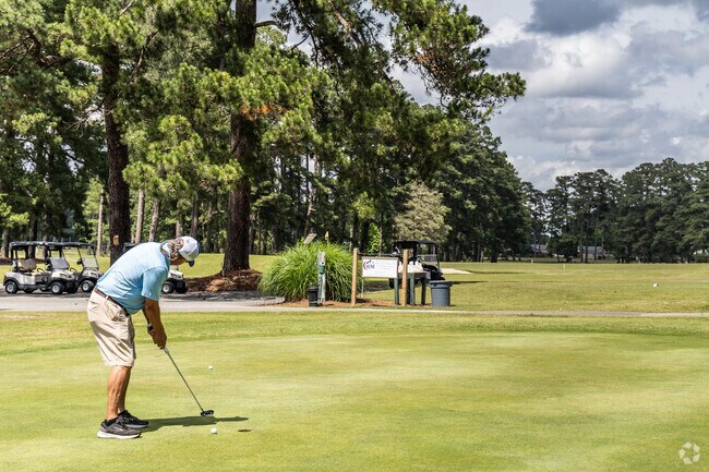 A golfer hones putting skills at Cypress Cove Country Club, nestled in the heart of Franklin, Virginia.
