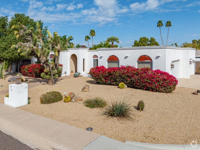 Spanish-style home in North Mountain Village, adorned with vibrant desert flora.