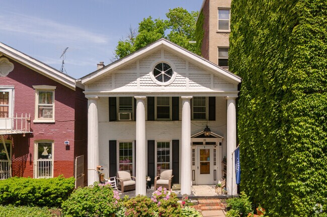 A Greek Revival home in Columbus offers an amazing park view from its front porch.