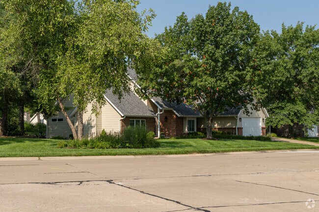Many homes in Green Meadows are shaded by large mature trees.