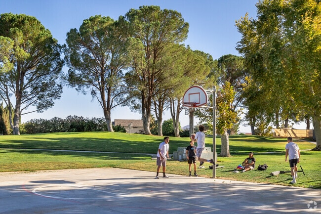 Teenagers play a game of hoops during their fall break at Hartford Park in Helendale.