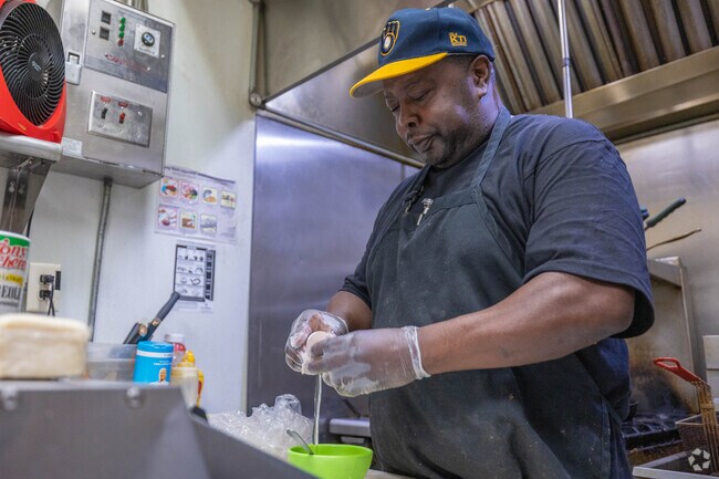 The chef at 4th Quarter Sports Bar cooks breakfast for Borchert Field residents.