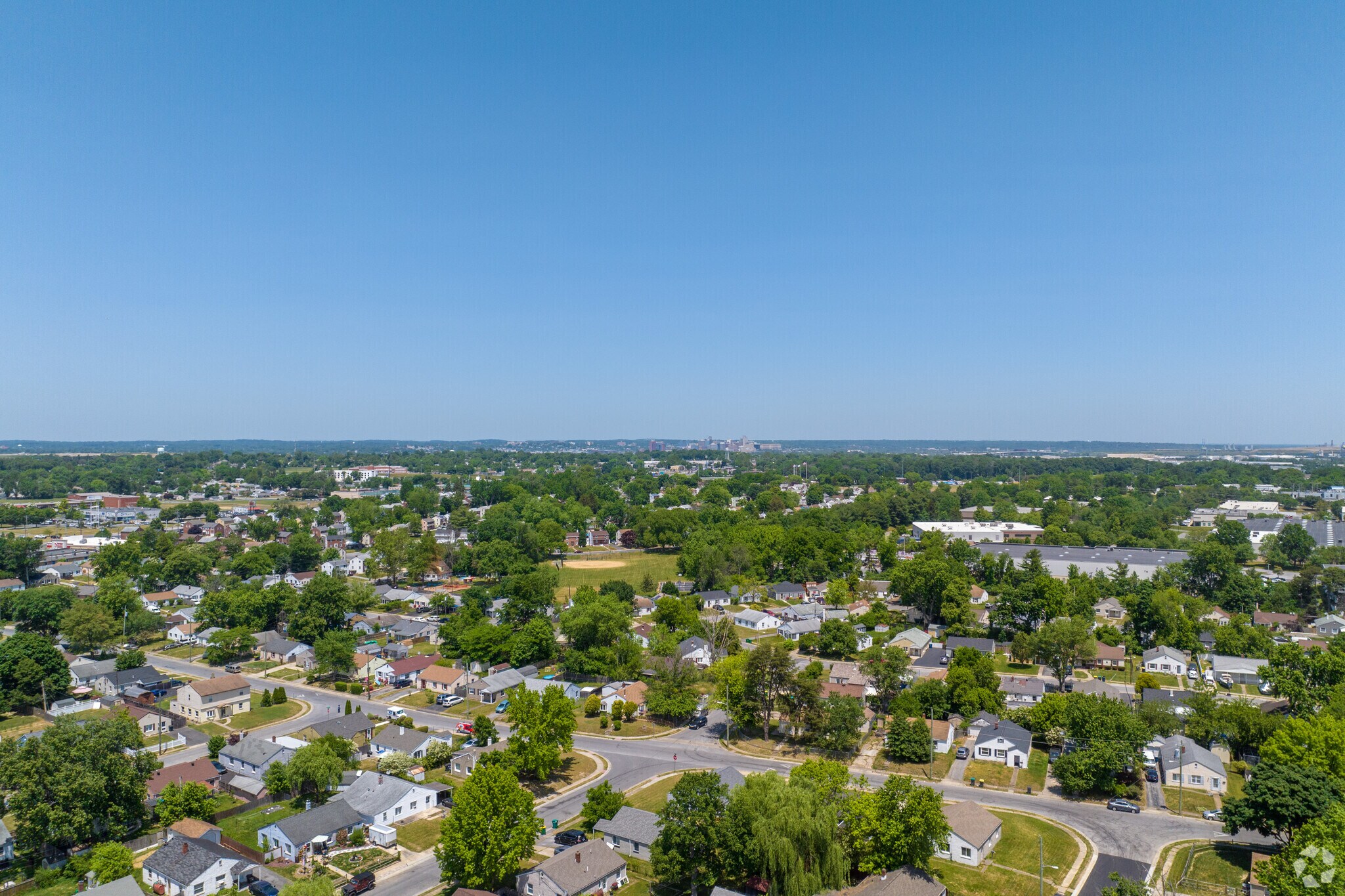 An aerial look over Collins Park with the Wilmington skyline in the distance.