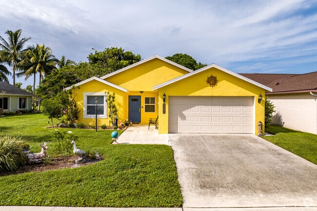 A colorful cross hipped ranch style home with an attached villa in Lakeside Green.
