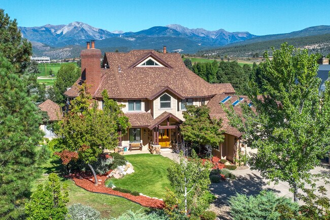 This beautiful home sits atop Hillcrest with stunning views of the mountain peaks beyond.