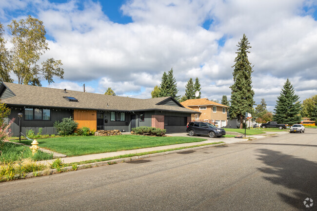 A row of houses with a modern ranch home sits on a quiet residential street in Weeks Field.