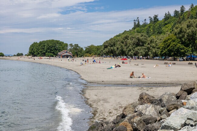 Beachgoers play in the sand at Golden Gardens park on Seaview Ave NW in Seattle.