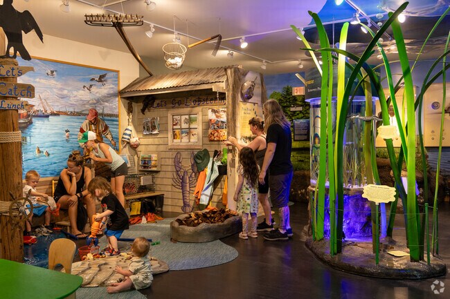Kids engage with hands-on displays at Great Bay Discovery Center in the Newington area.