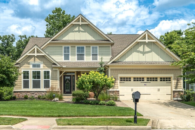 A two-story craftsman home in Antrim features a well-manicured front yard.