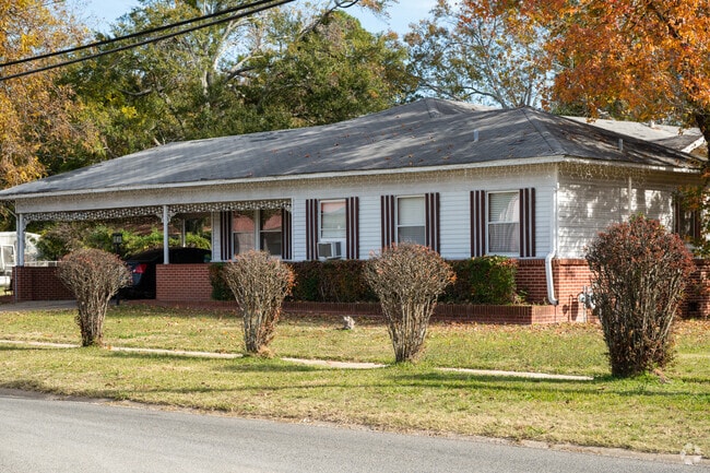 Wood and brick is an elegant ranch style with the carport on the side, in Mansfield, LA.