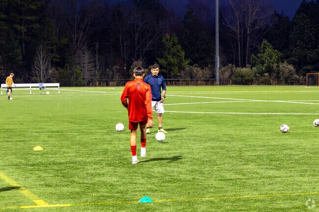 You will find people practicing on the fields at Elon Park at all hours of the day.
