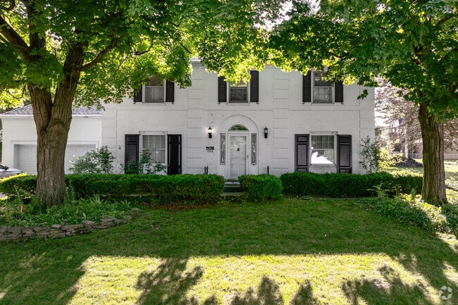 Mature trees in front yards give shade to sidewalks and homes in College Hill.