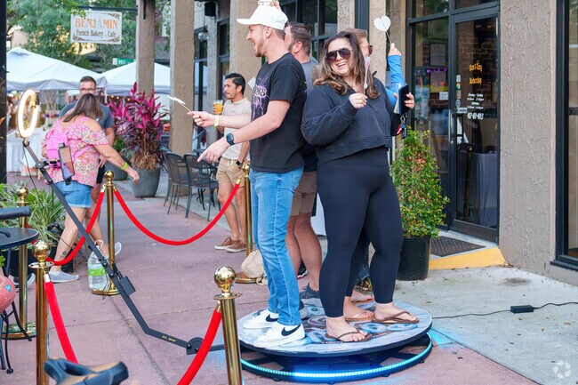 Thornton Park residents laugh while taking photos at the Wine Walk and Art Festival.