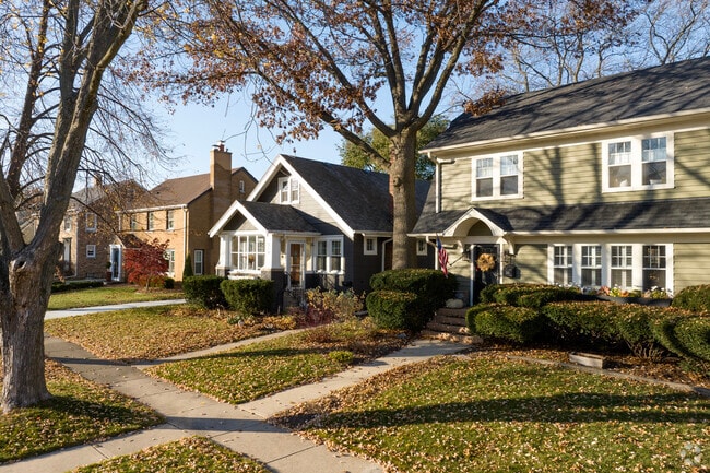 Modern and traditional builds sit beneath old trees in Allendale, Wisconsin.