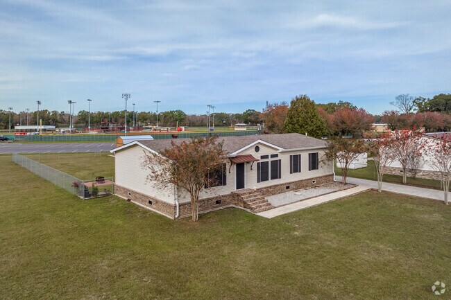 A one-story, Ranch-style home with a long driveway and attached deck in Mills North.