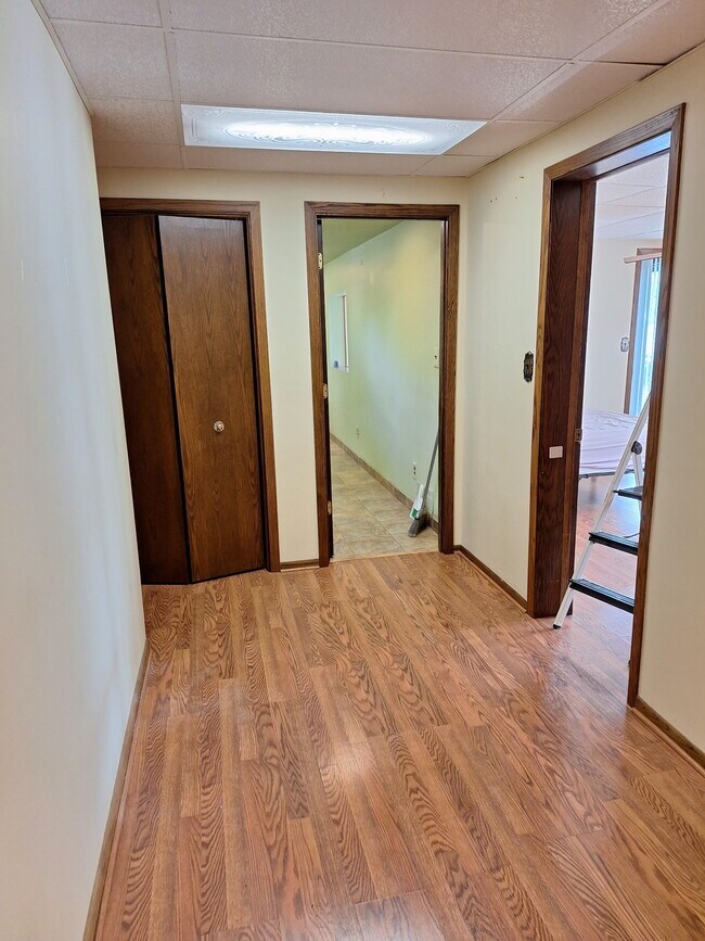 Connecting room. Closet left, kitchen entrance, master bedroom and 2nd bedroom to right