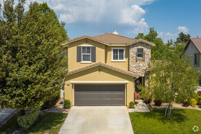Beautiful front yard and trees seen in front of a Fairway Canyon home.
