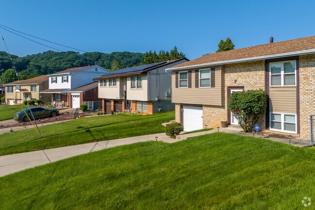 Bi-level homes have attached garages for secure parking in the neighborhood.