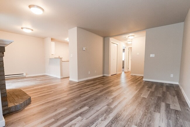 Puyallup Apartments - Cambridge on Seventh Apartments - Living Room, Fireplace, Dining Room, Kitchen, and Entryway