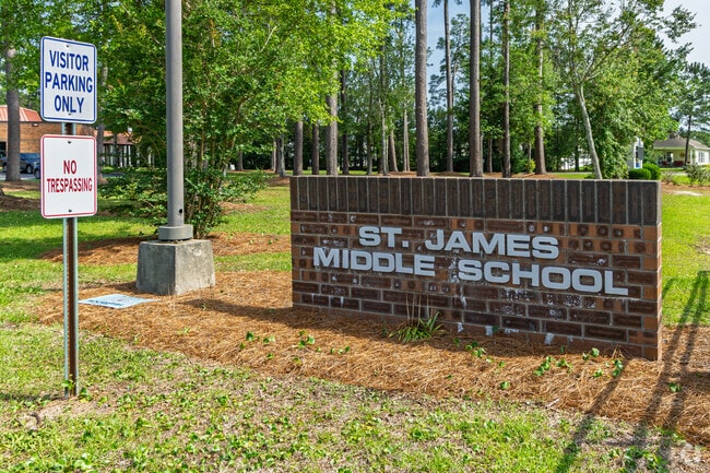 A brick monument sign marks the visitor entrance of St. James Middle School.