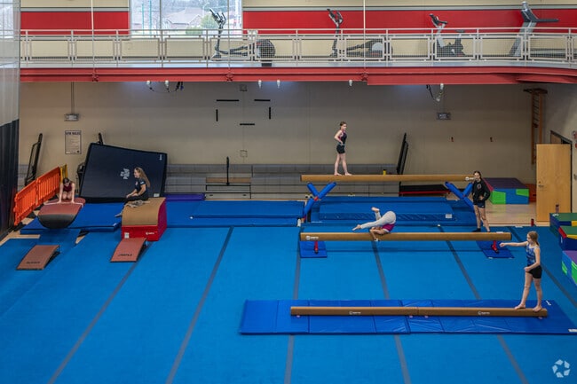 Athletes practice on balance beams at the Burbank gymnastics gym.