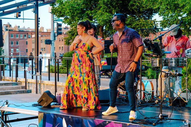 Gaby Cotter & The Timba Messengers show their best latin jazz dance moves as the sing.