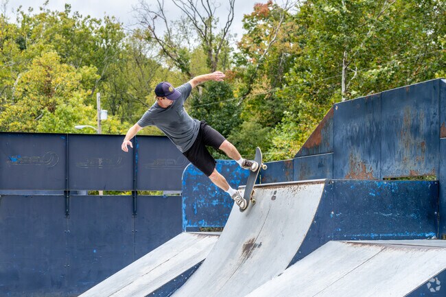 A young man from the Jerome Park neighborhood area goes skateboarding after work.