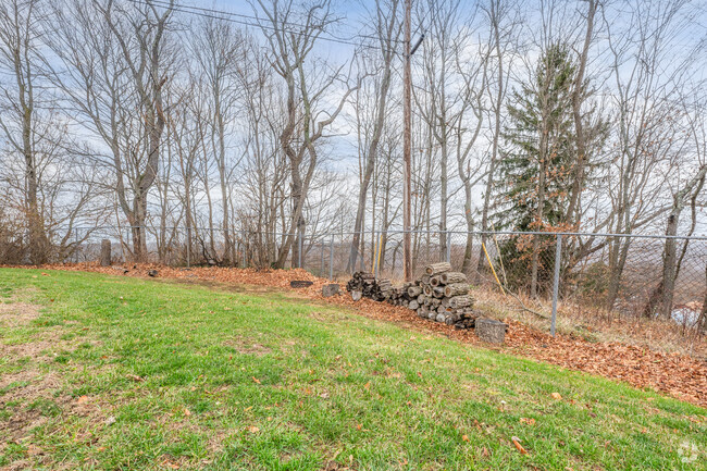 A neighborhood fire pit sits on the bend of a street in Culler Road.