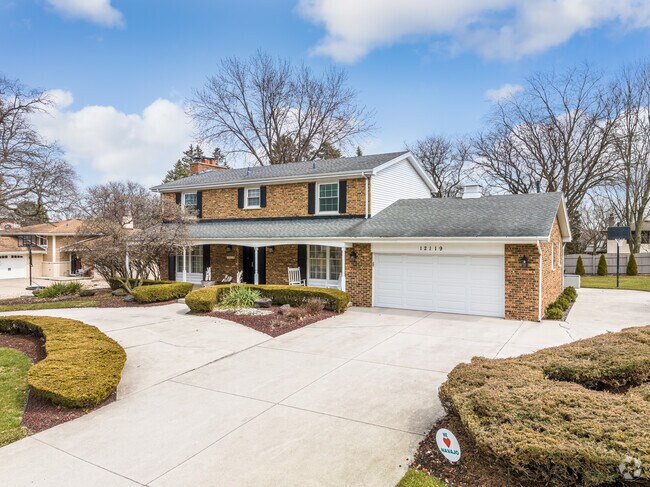 A brick two-story home with an attached garage in the Navajo Hills neighborhood.