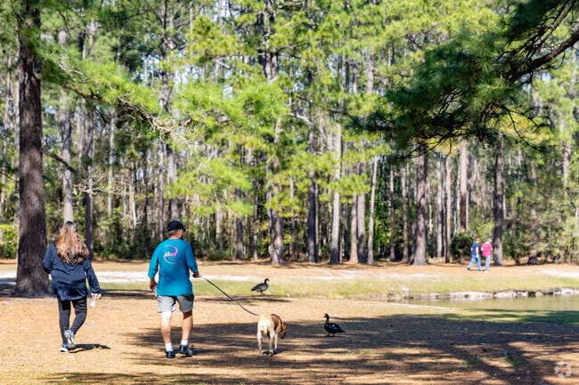 Residents walk the dog along the pond in Asbury Lake.