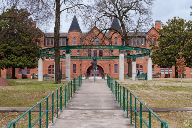 A peaceful, scenic walkway leads to the statue at Northeastern State University in Tahlequah.