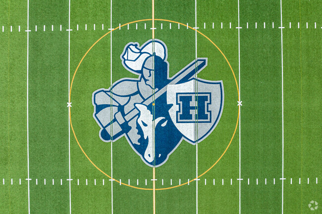 The Hudson Raiders logo is featured on the stadium field.