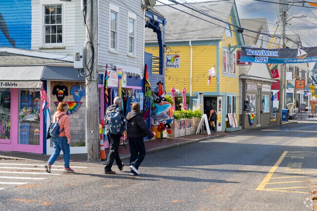 Colorful storefronts line Provincetown streets during TransWeek celebrations.