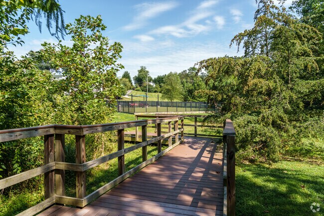 A wooden boardwalk serves as a trail for dogs and people to get some exercise at Triangle Dog Park.