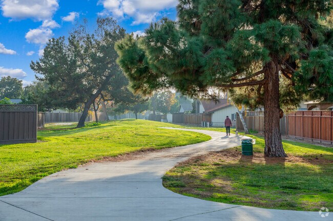 Resident takes his dog for a walk through Brookvale Plaza Park & Trail near Cabrillo.