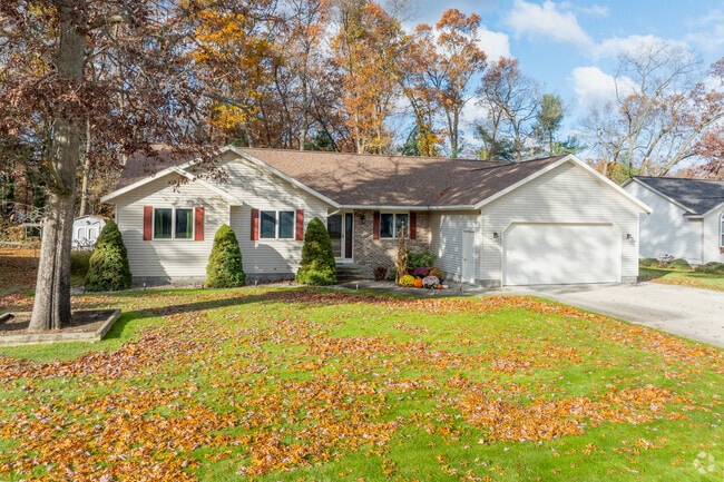 Ranch‑style homes line tree‑shaded streets in Muskegon Township.