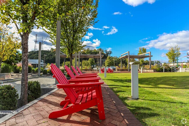 The town of Cedarwood has many green spaces with benches and chairs for the residents to enjoy.