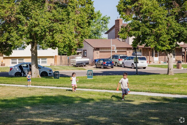 Kids flock to the playground at Laura's Park in Pueblo.
