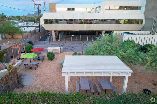 Phoenix Modern has a small outdoor play area with several picnic tables.