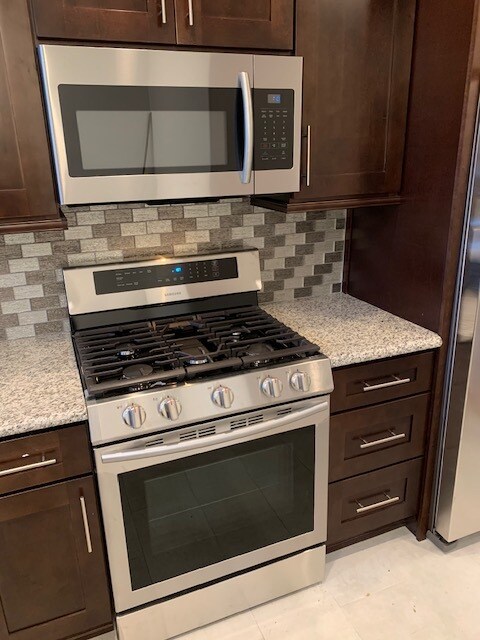 Stainless steel stove, oven and microwave. Granite countertops.