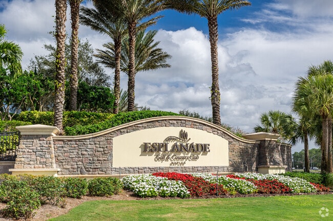 Esplanade Golf and Country Club residents are welcomed by a fountain and lush landscaping.