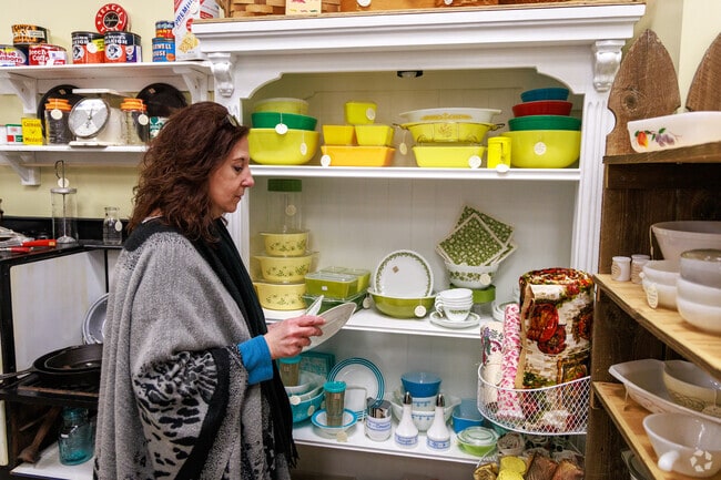 A woman looks through some vintage stoneware at The Eclectic Chic in Oneida.