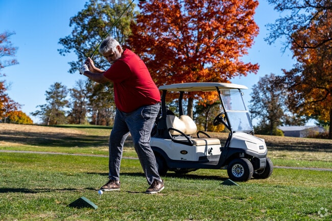 A golfer tees off at Sanctuary Lake Golf Course in Rochester Hills.