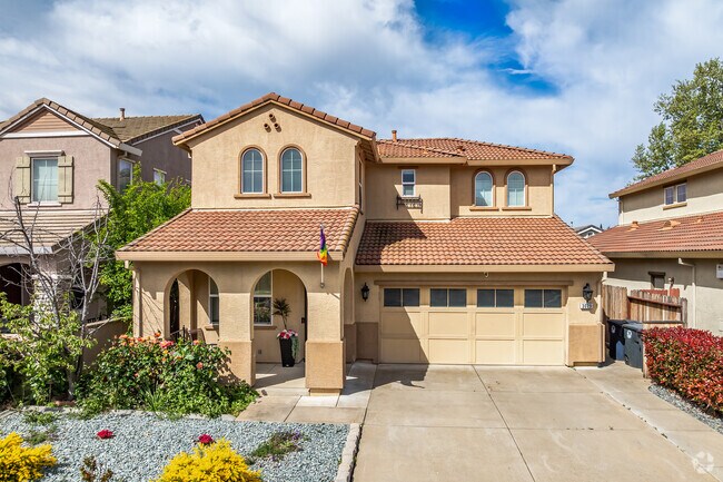 This Spanish Revival-style home is a 2 story with an arched entryway in Countryside.