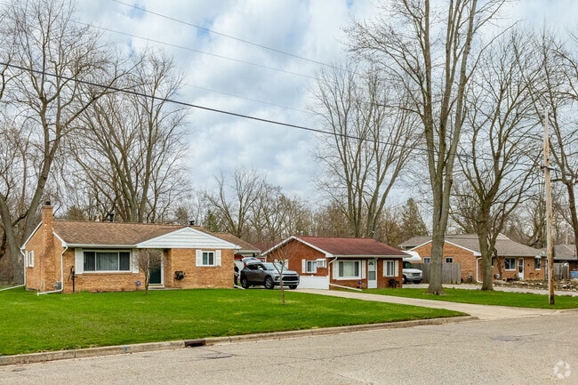 Brick ranches on the north side of Pleasant Grove sit on long wooded lots.