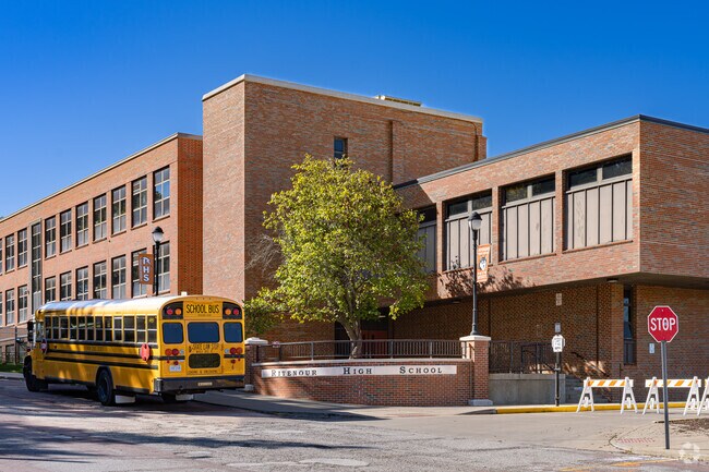 A school bus picks up students at the entrance to Ritenour Sr. High School.