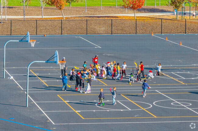 Kids at Fiddyment Farm Elementary School practice hockey for physical education.